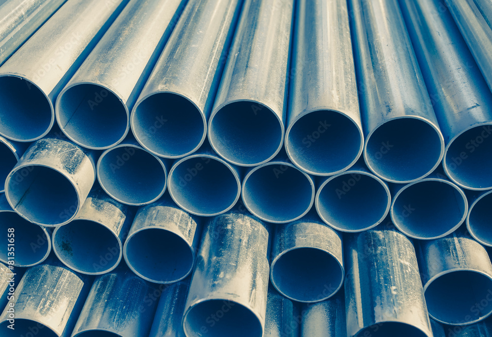 Close - up Stack of construction metal pipes .
