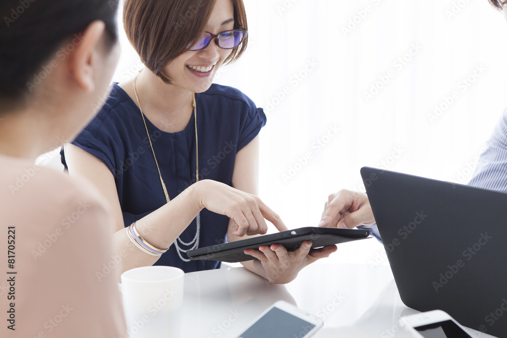 Woman looking at the electronic tablet with a smile