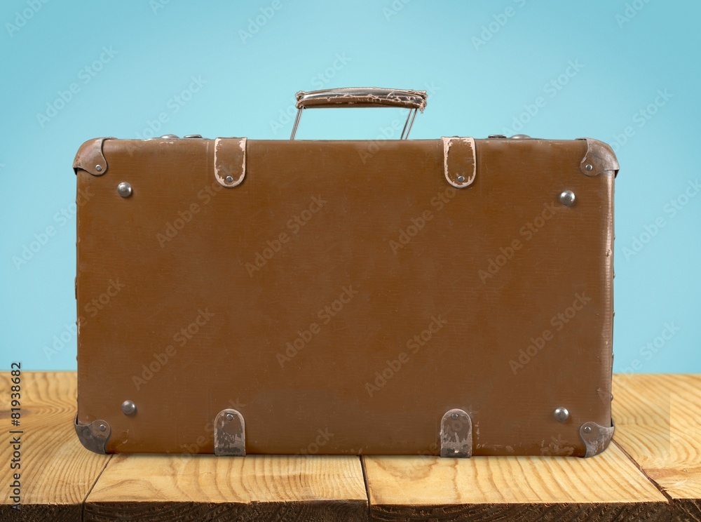 Brown. Antique or retro luggage or suitcase on a white