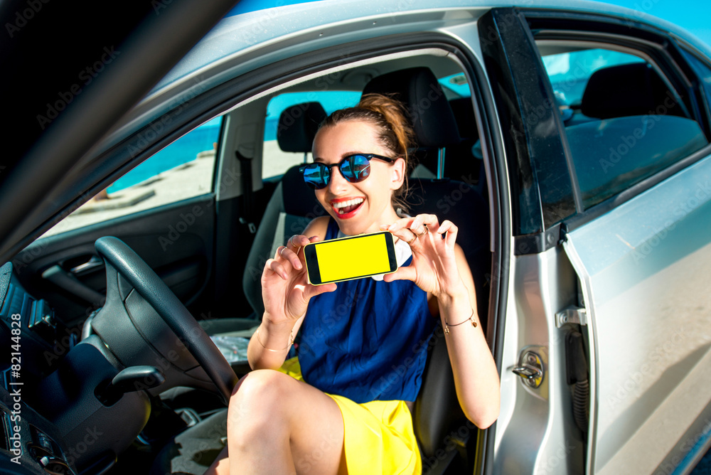 Woman showing phone screen in the car