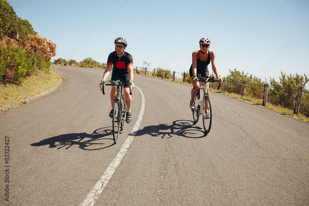 Cyclists riding down a country road