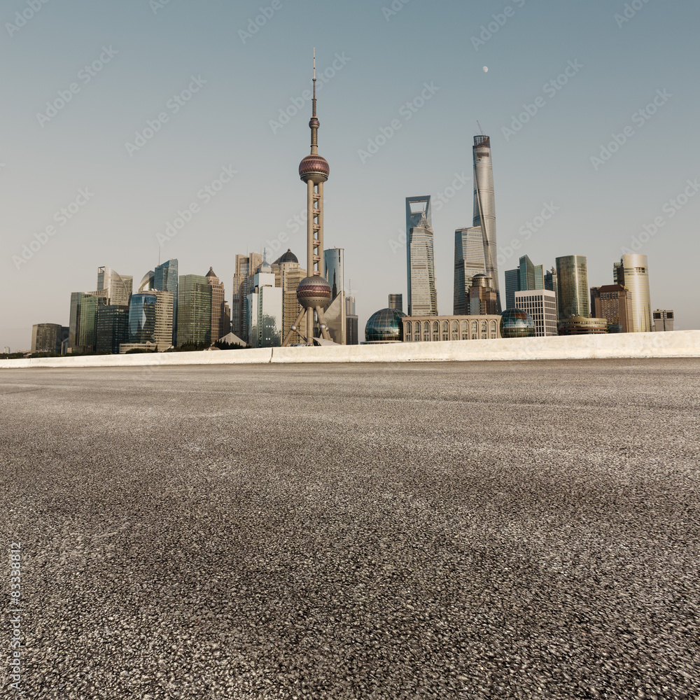 Asphalt road in front of the modern building， in Shanghai，china。