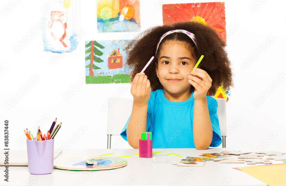 African girl holds cuisenaire rods learn to count