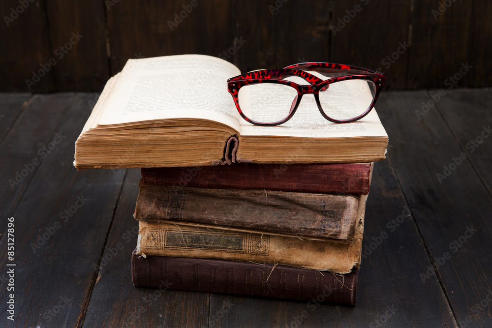 Vintage reading glasses on the books stack