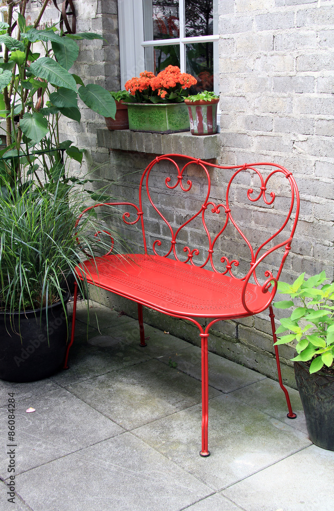 Red bench outside on a patio