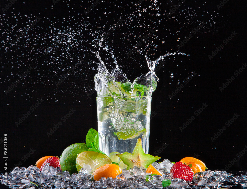 Mojito drink with splash on black background
