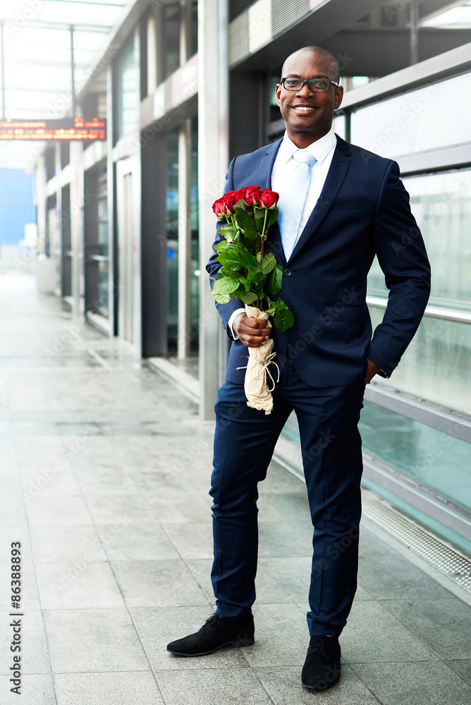 Happy Businessman Waiting at the Metro with Roses