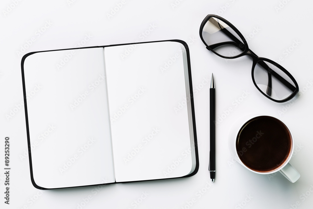 Blank diary, cup of coffee and glasses, on a white background
