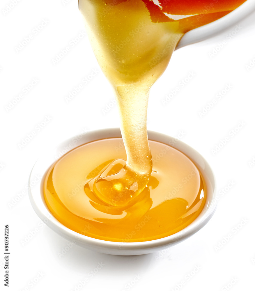 honey pouring into bowl