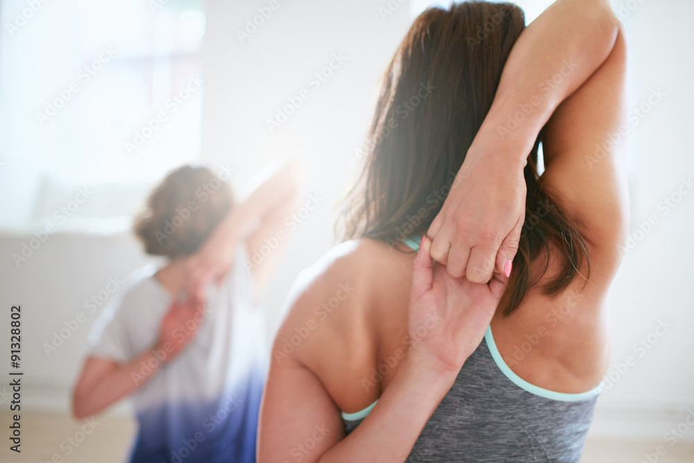 健身女性在瑜伽课上做gomukhasana