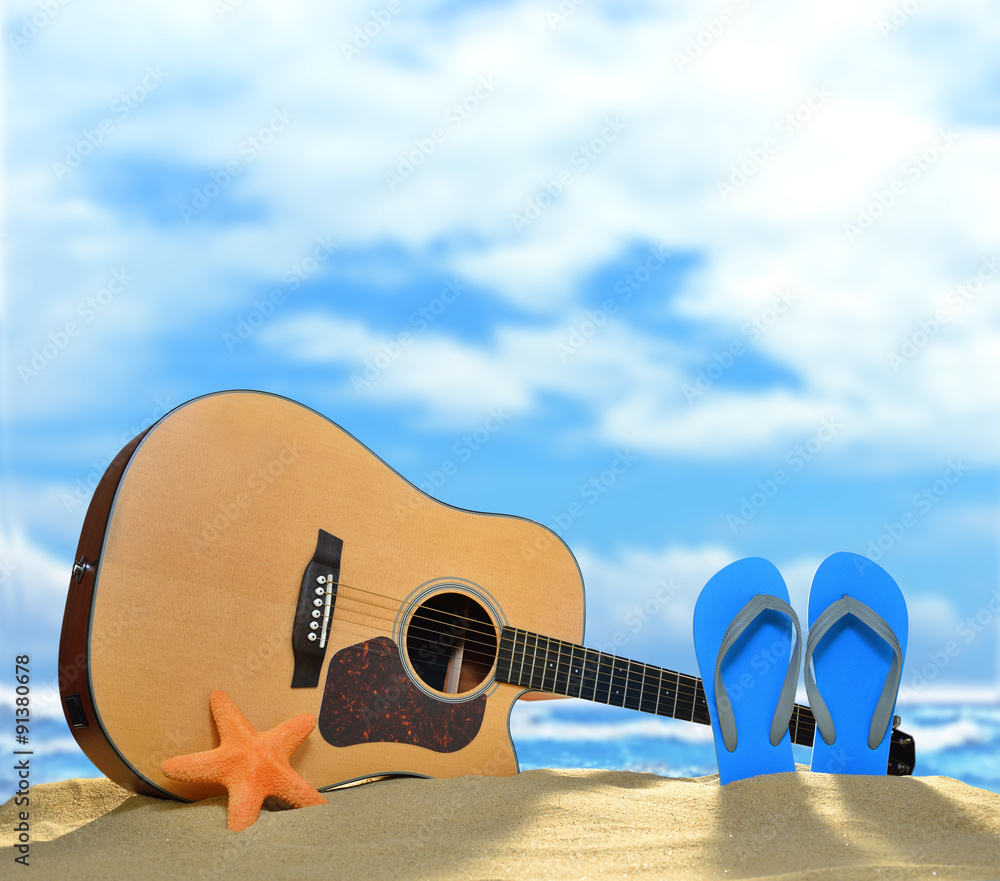 夏日碧海蓝天沙滩上的原声吉他和人字拖