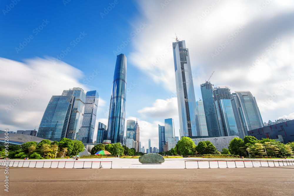 modern square and skyscrapers under blue sky