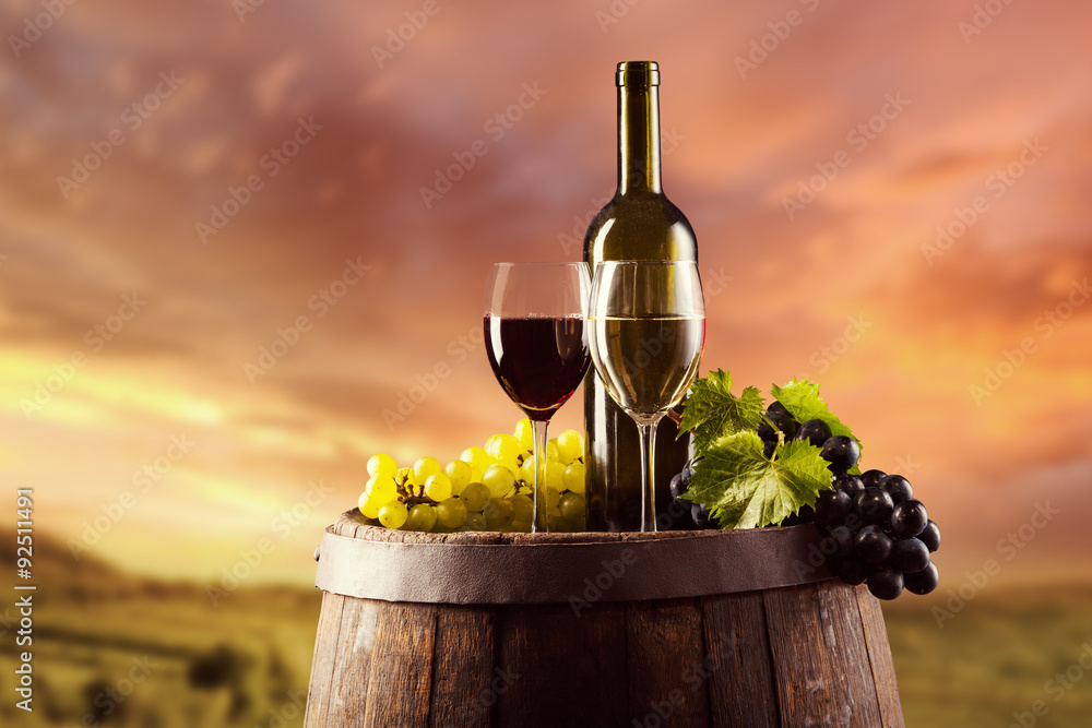 wodden桶上的红白葡萄酒瓶和玻璃杯