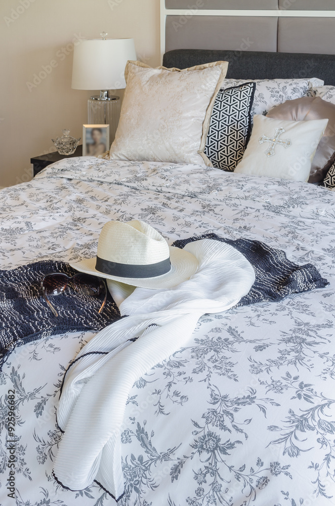 modern bedroom with hat, sunglass, and clothes on blanket