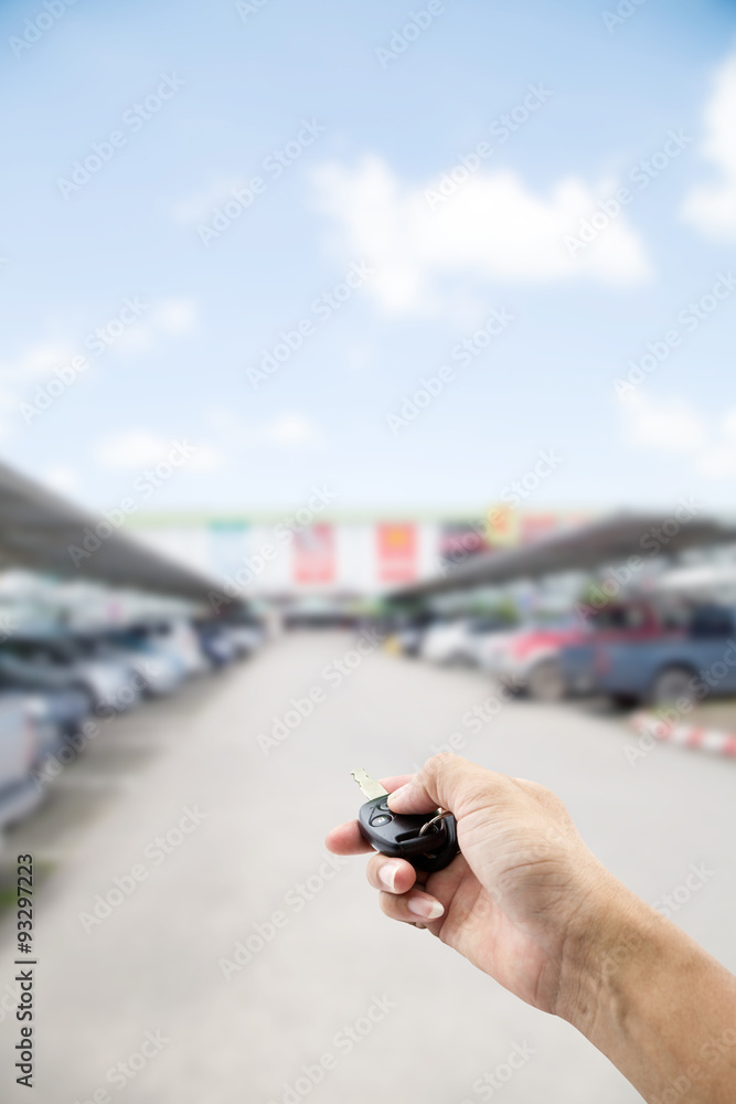 Hand male asia ,holding car remote on Abstract blur background o