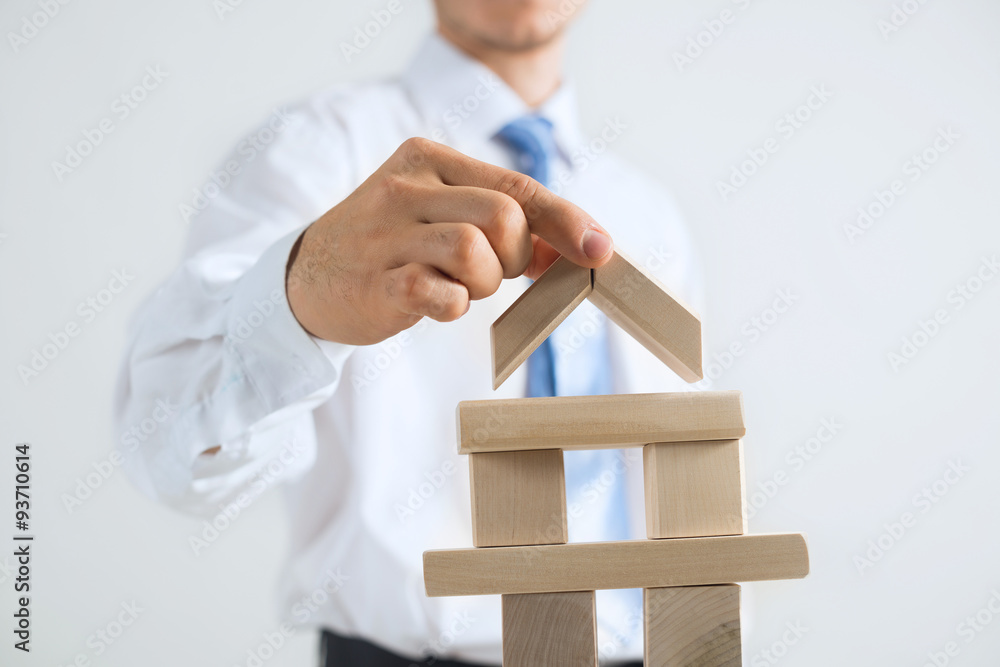 Businessman making tower