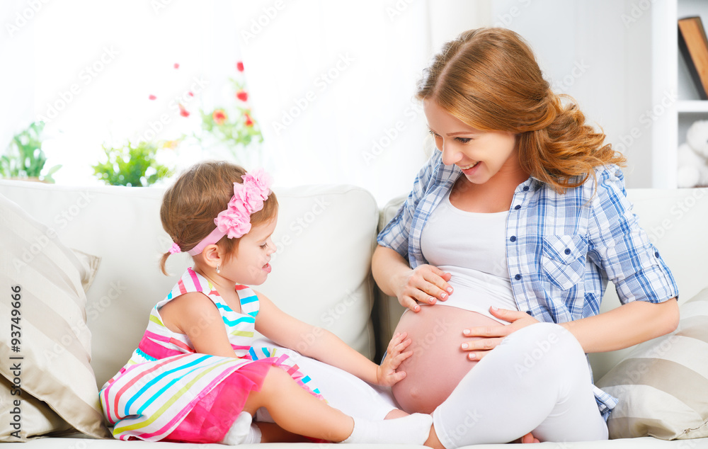 happy family. Pregnant mother and baby daughter having fun relax