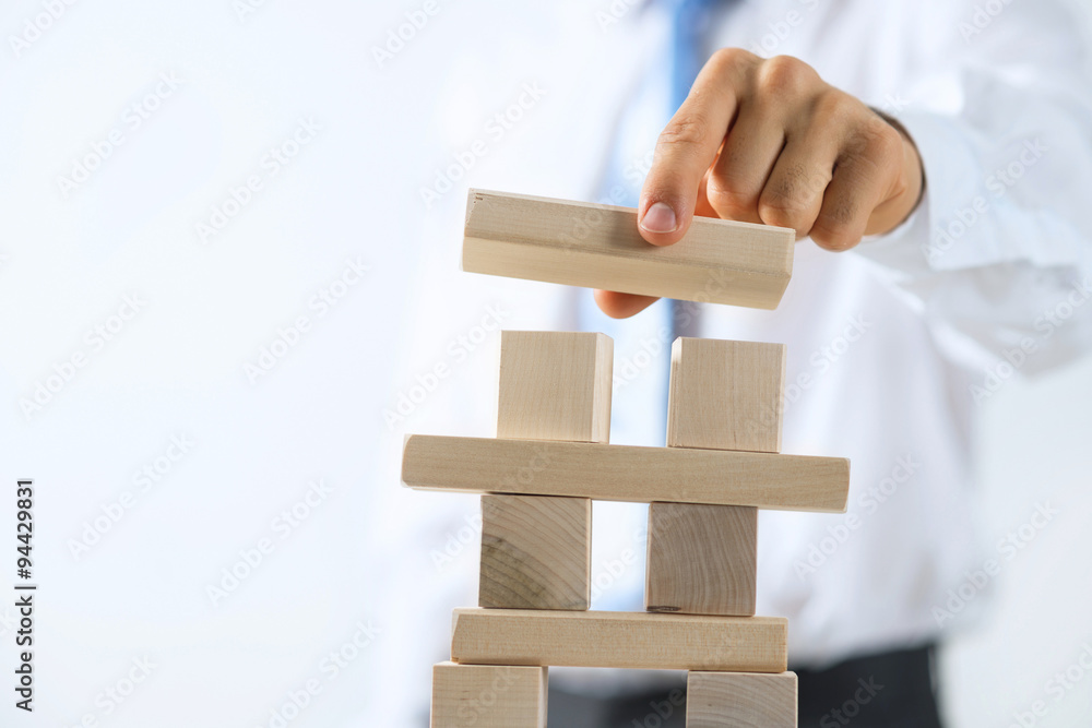 Businessman making tower