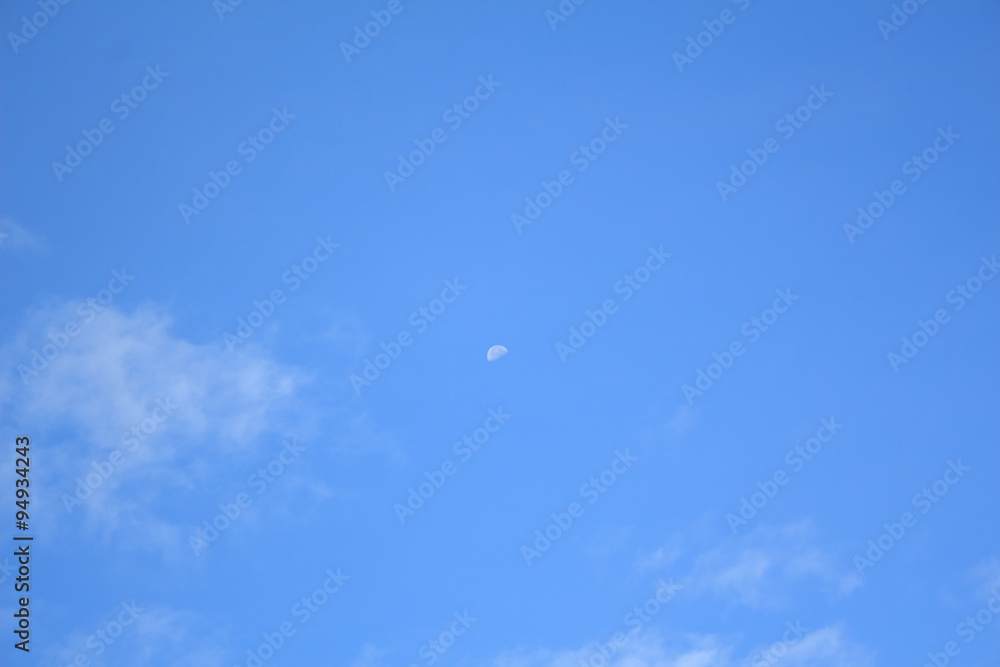 blue sky with moon and clouds