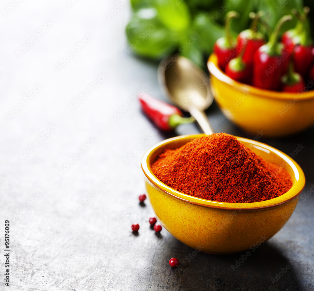 Paprika in a bowl and hot chili peppers