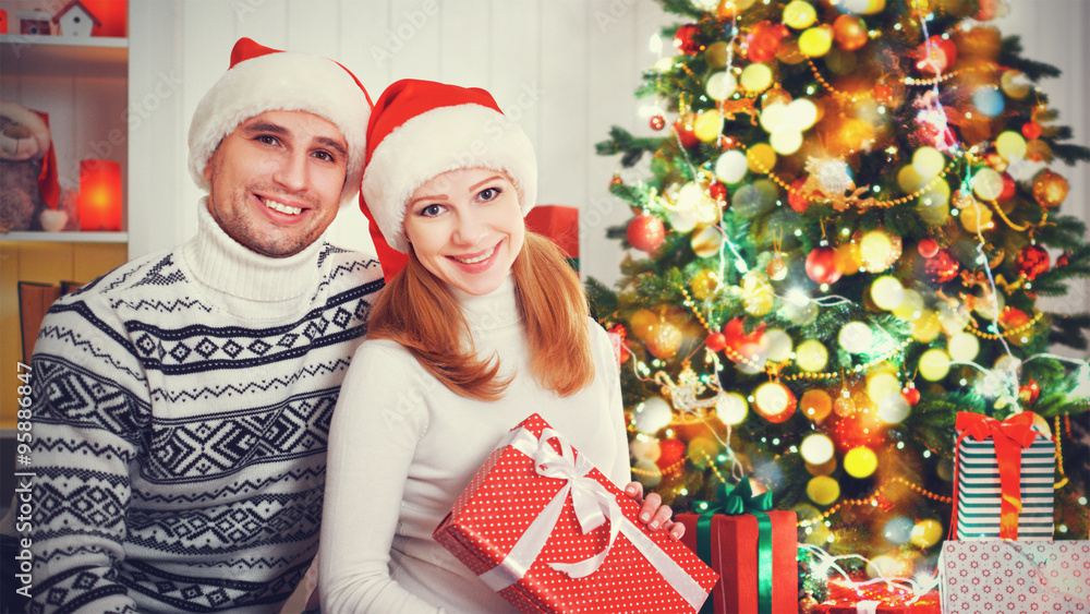 happy  family couple with a gift on Christmas at home