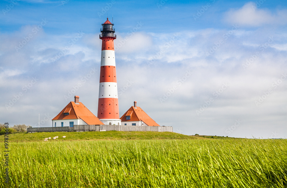 Traditional lighthouse at North Sea with blue sky and clouds