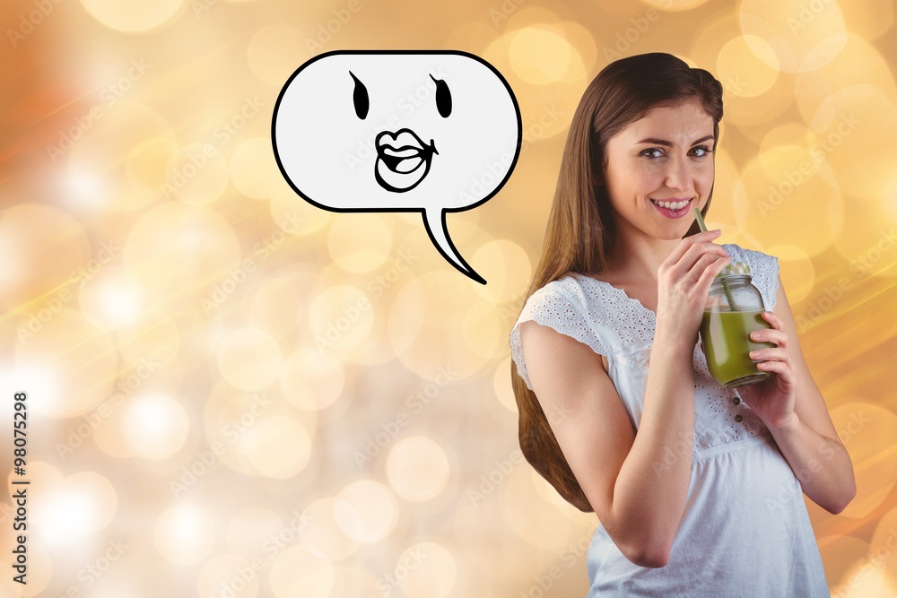 Composite image of pretty woman sipping on green juice
