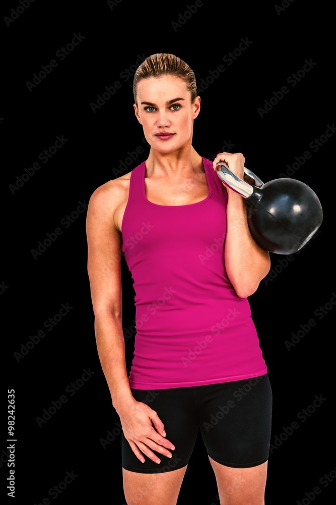 肌肉发达的女性用壶铃锻炼的合成图像