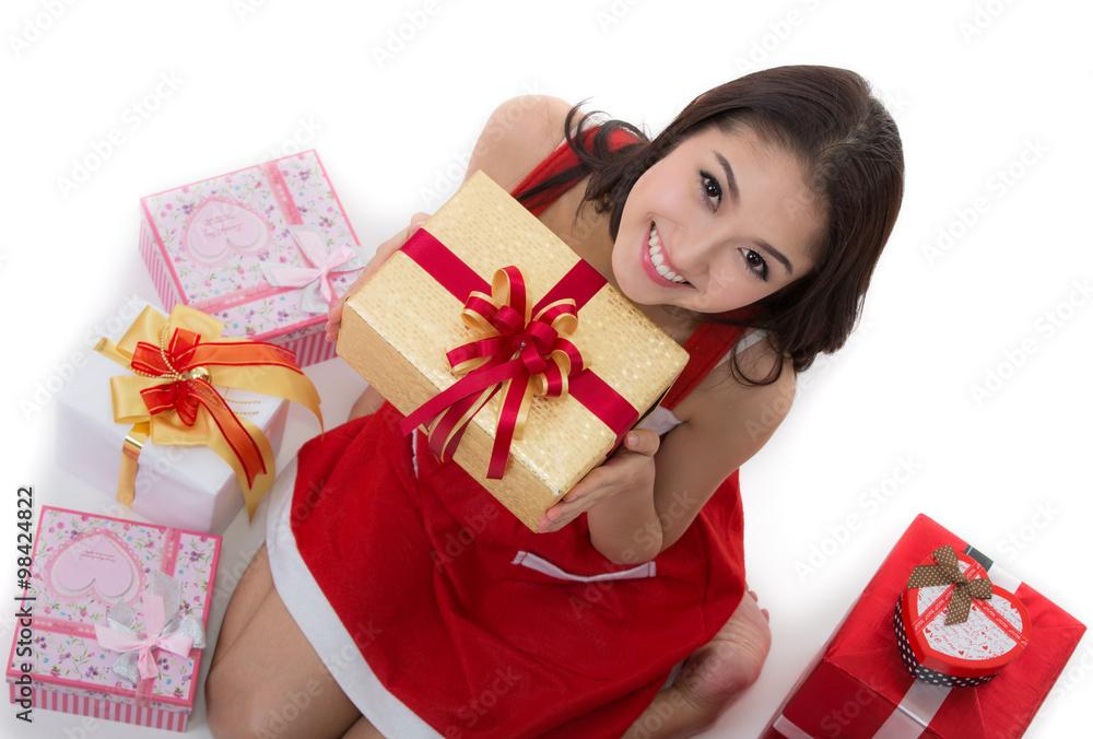 美丽的亚洲女人穿圣诞老人装，圣诞女孩开心微笑，拿着新年礼盒公关