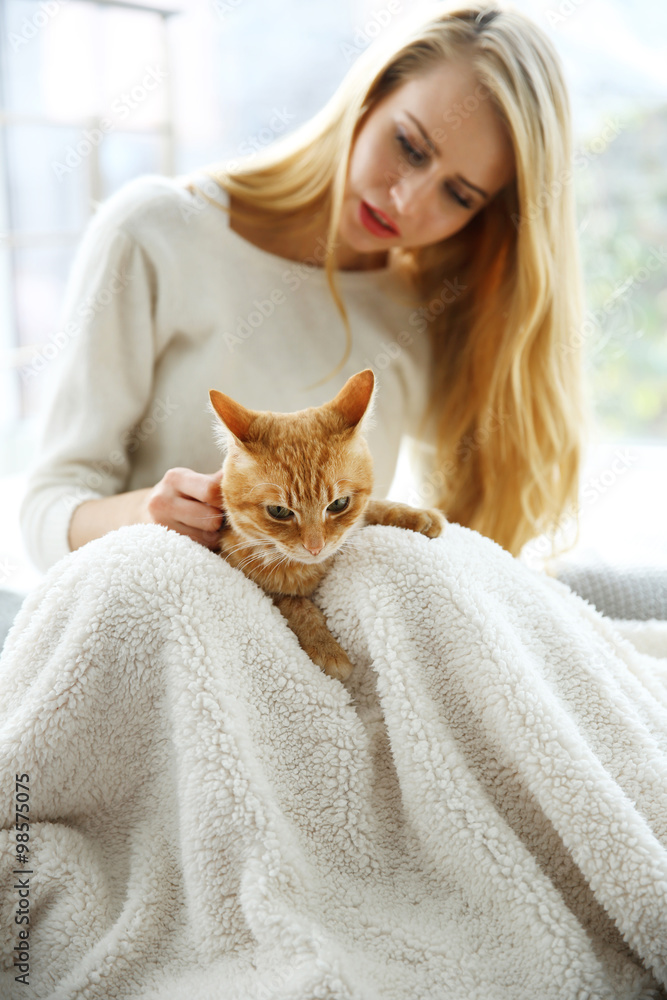 Attractive woman posing with red cat
