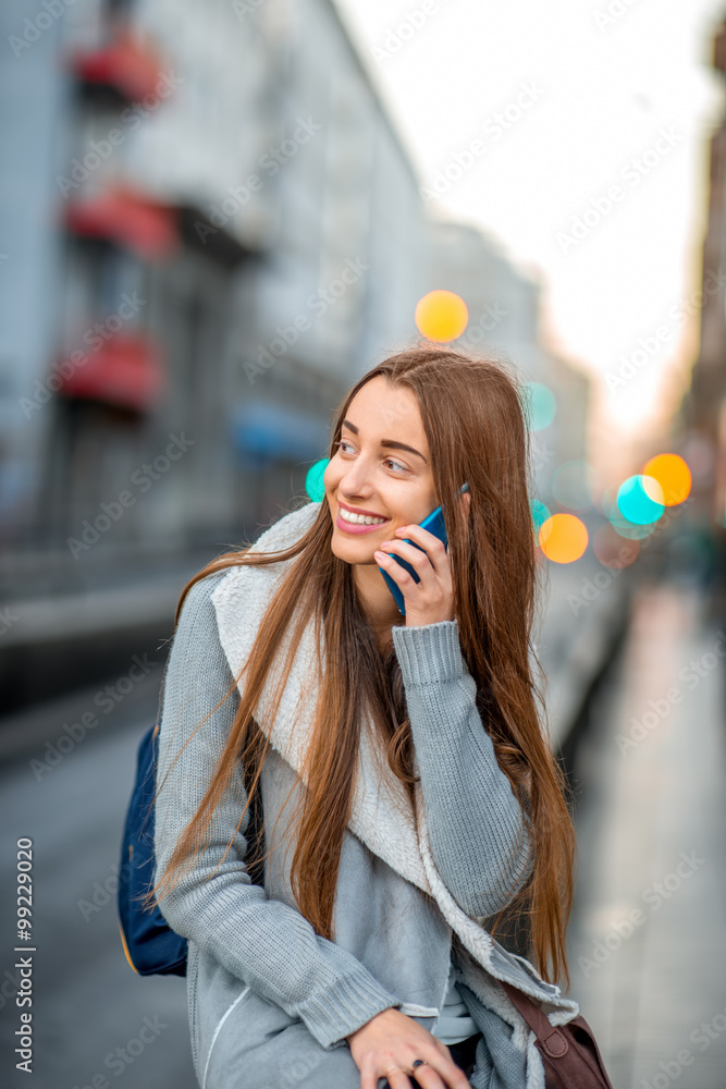 Woman with phone in the city