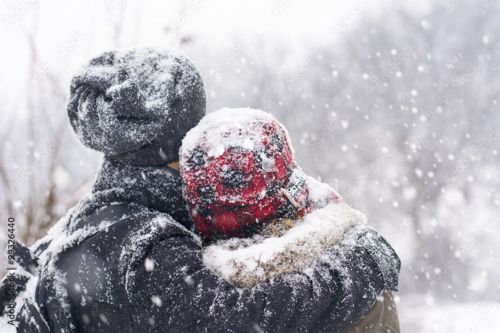 Couple in love outdoors hugging on a winter day