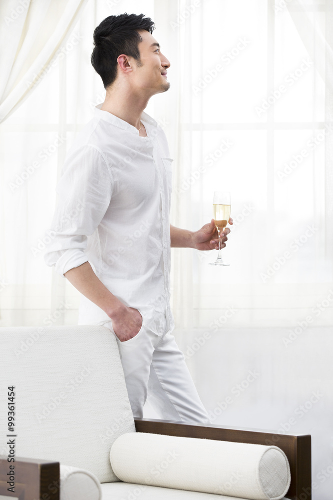 Happy young man with champagne