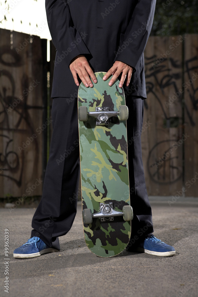 Young Businessman With Skateboard
