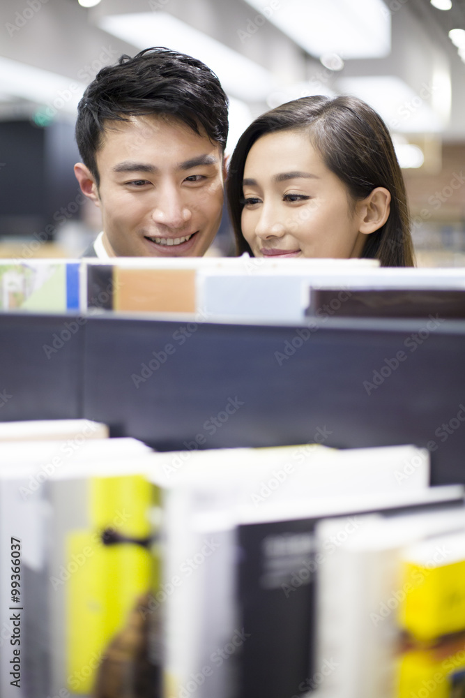 年轻夫妇在书店选书