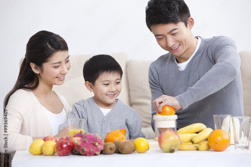 Happy family making juice at home