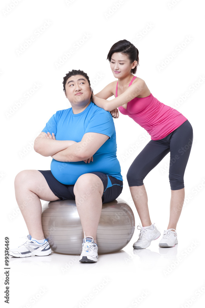 Happy Chubby man and girlfriend with fitness ball