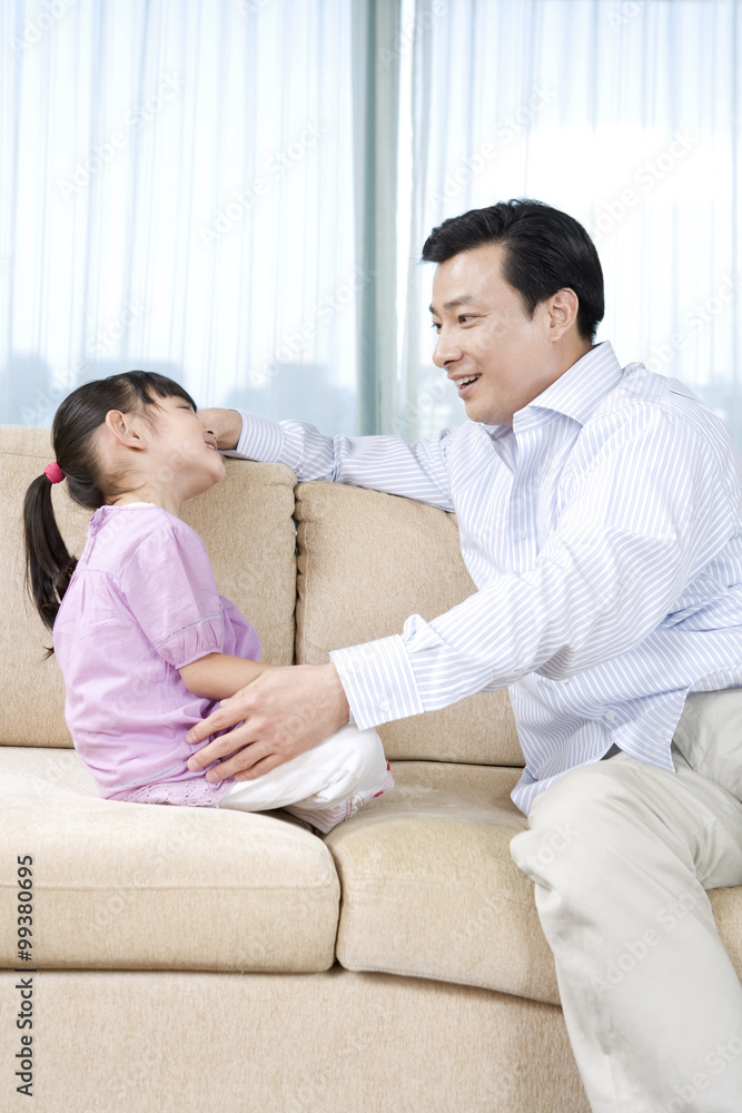 Girl and father on couch