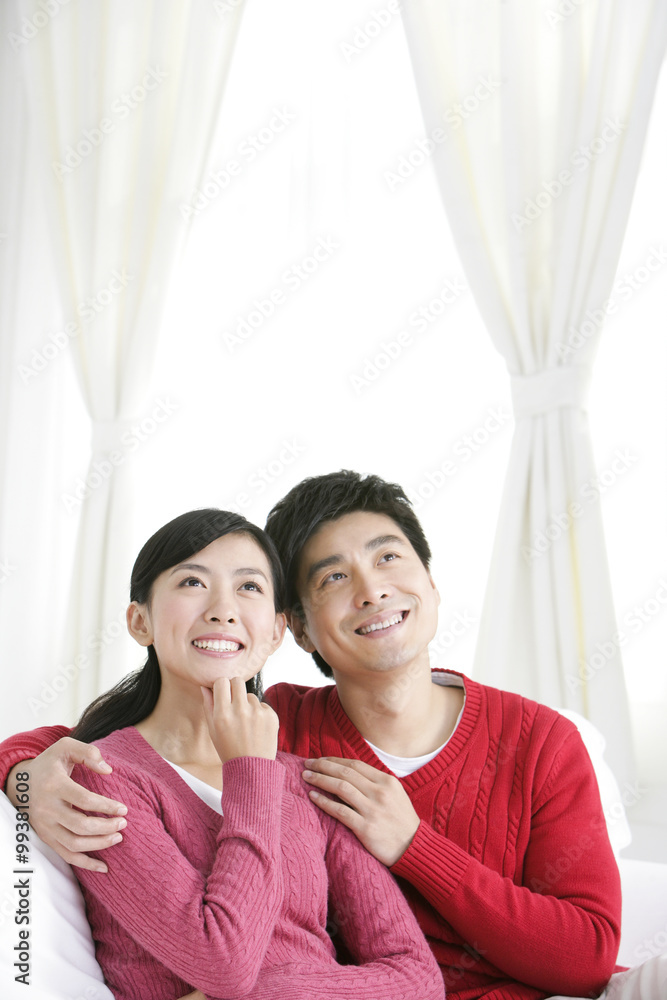 Young Chinese couple in living room