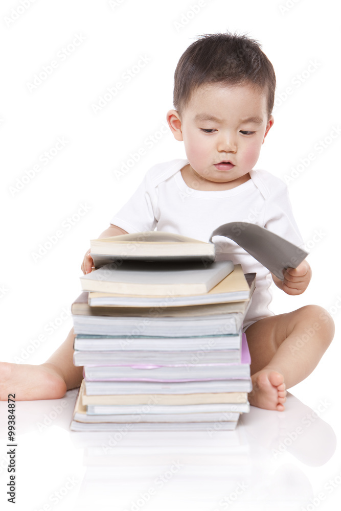 Adorable baby boy with books
