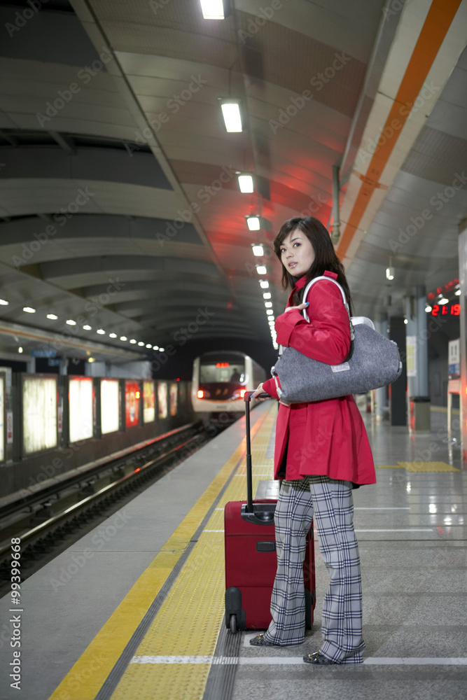 Woman Waiting For Train At Station