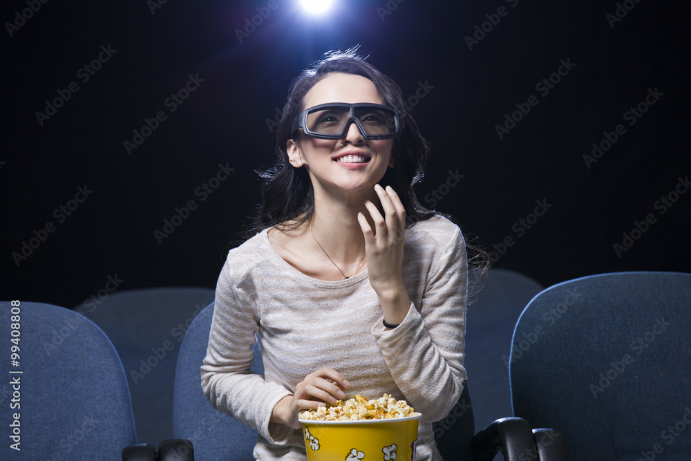 Young woman watching 3D movie in cinema