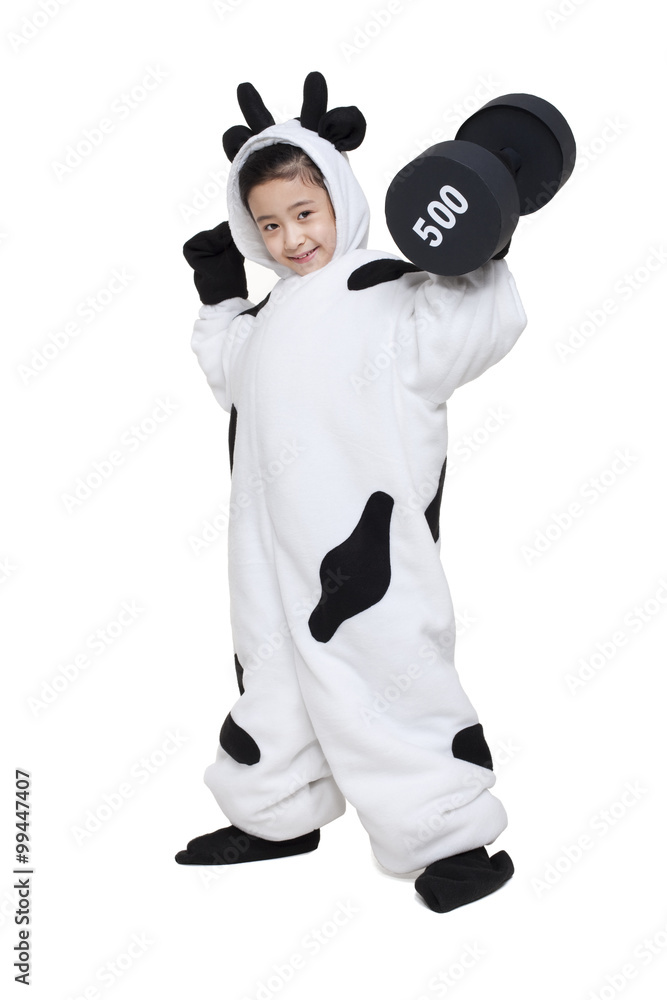 Cute girl in a cow costume flexing and lifting a dumbbell