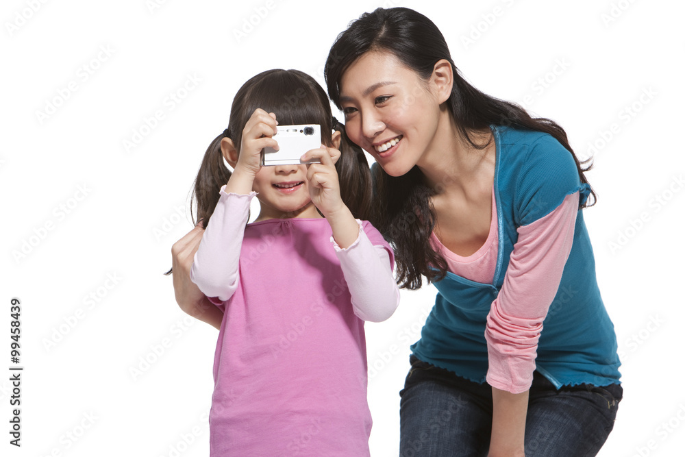 Happy mother and daughter holding a camera