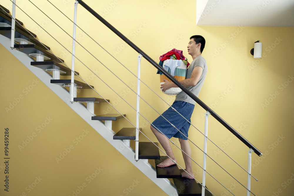 Portrait Of Man With A Clothes Basket On A Staircase