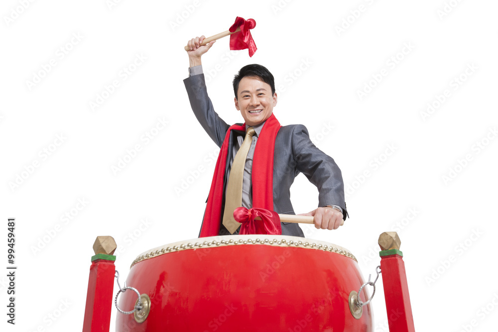 Businessman playing traditional Chinese red drum