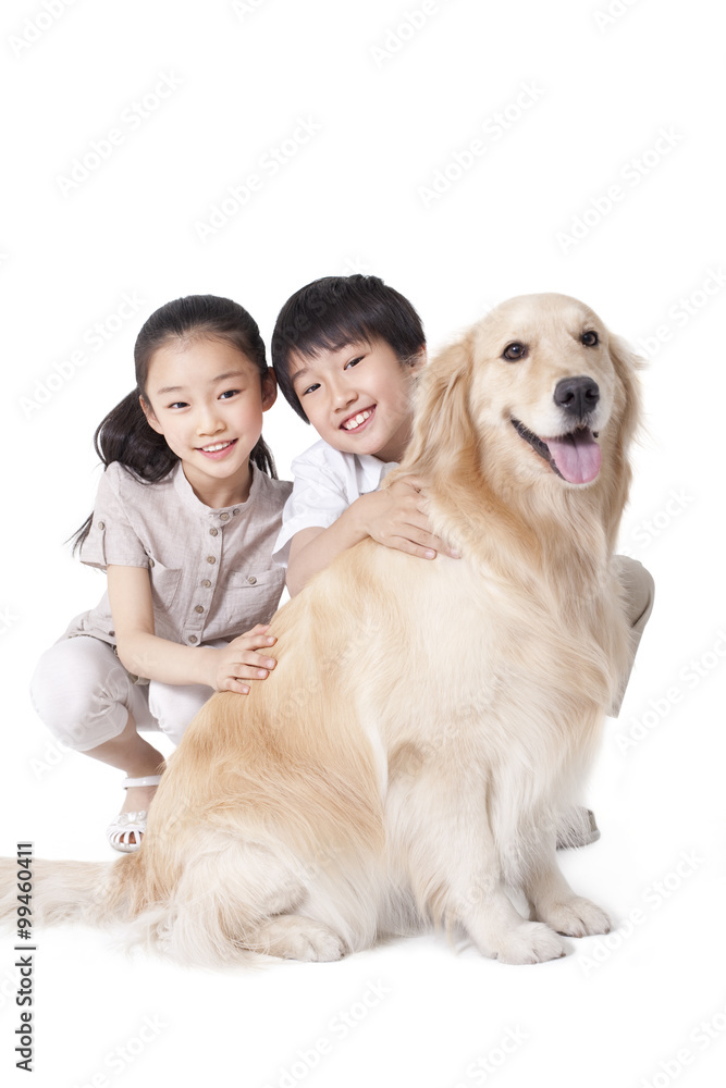 Siblings petting a dog