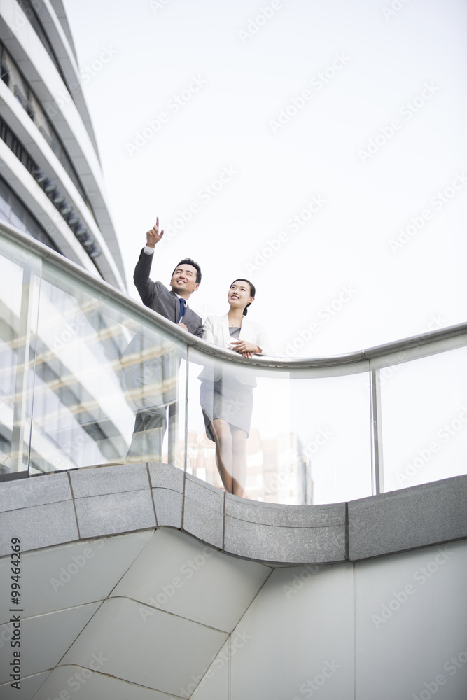Business person pointing and looking at view