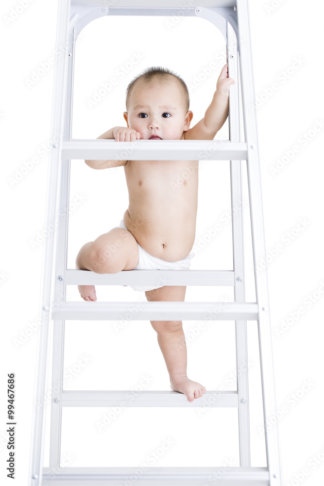 Cute baby boy climbing ladder