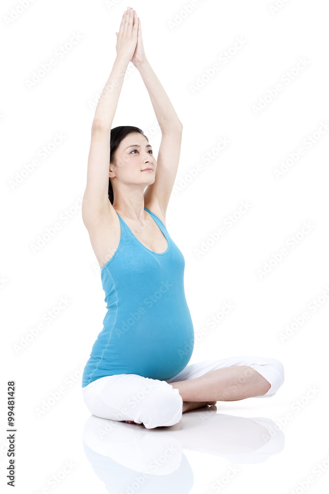 Young pregnant woman doing yoga